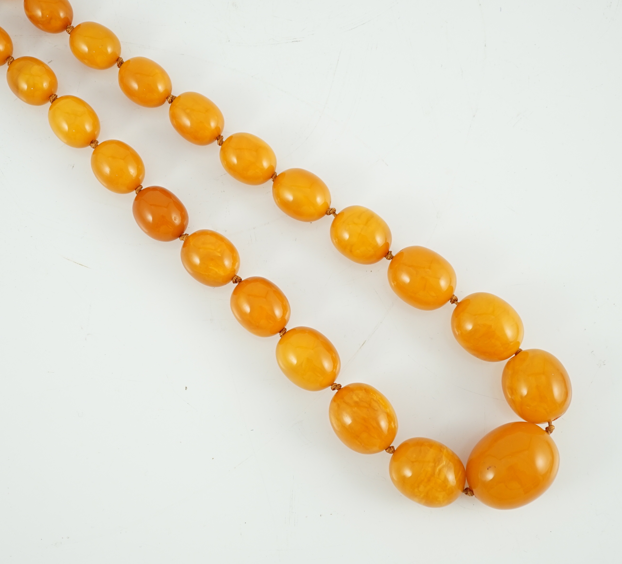 A single strand graduated oval amber bead necklace, 110cm, gross weight 163 grams